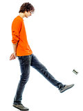 young man walking kicking tin can  side view