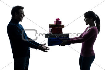 couple woman man offering christmas gifts  silhouette
