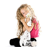 Little girl hugging pacifier and blanket smiling cheerful