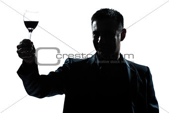 man rising up toasting his glass of red wine 