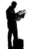 silhouette man full length standing reading newspaper 