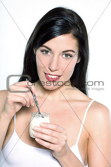 young caucasian woman portrait  eating yogurt