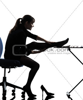 business woman massaging her leg silhouette