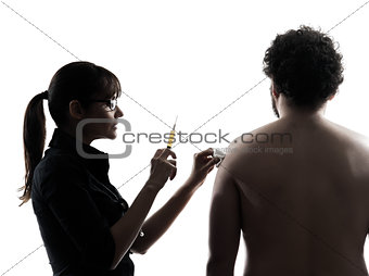 woman doctor holding surgical needle vaccination silhouette
