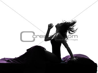  woman happy awakening sitting in bed silhouette
