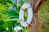 White life preserver hanging on a wooden post