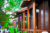 Wooden balconies bungalows in a tropical garden.