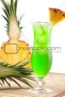 Green tropical cocktail with pineapple slice