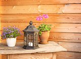 Flowers and old lantern on a wooden table
