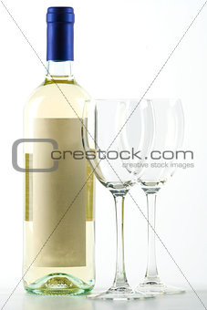 Bottle of white wine and empty wine glasses 