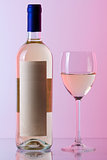 Bottle of white wine and wine glass in red gamma