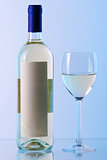 Bottle of white wine and wine glass in blue gamma