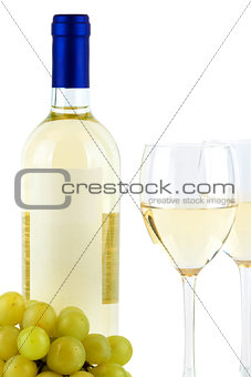 Bottle of white wine and two wine glasses and grape
