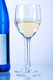 Blue bottle of white wine and two wine glasses