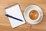 Blank notepad with pen and cappucino cup