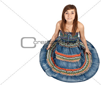girl sitting on the floor in the denim dress