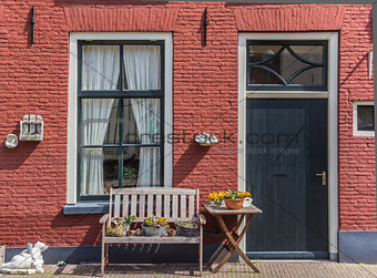 Red house with a bench