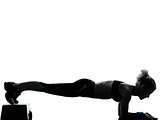 woman exercising step aerobics push ups 