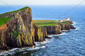 View of Neist Point lighthouse and rocky ocean coastline, Scotla