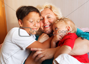 Happy grandmother hugging with her grandsons