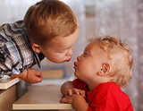 Cute siblings. Two little brothers are kissing.