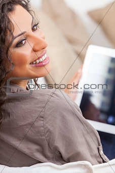 Hispanic Woman Laughing Using Tablet Computer