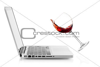 Wine falling on laptop