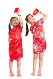 Asian girls peeking into red packet