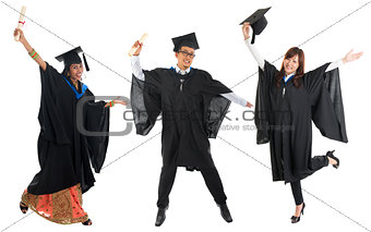 Multi races university student in graduation gown jumping