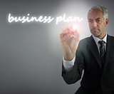 Serious businessman writing business plan
