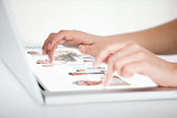 Close up of hands choosing pictures on a futuristic laptop