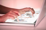 Close up of hands picking pictures on a futuristic laptop