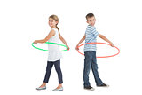 Brother and sister playing with hula hoop