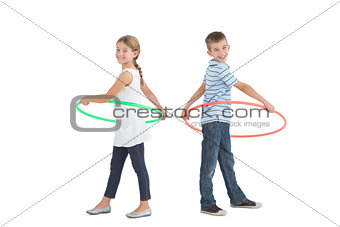 Brother and sister playing with hula hoop