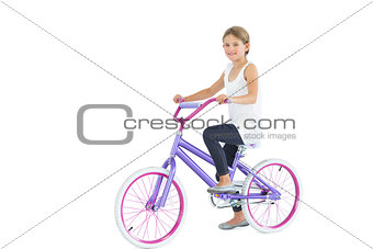 Smiling cute young girl riding bike