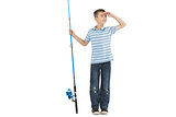 Young boy holding fishing rod looking away