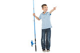 Young boy holding fishing rod pointing