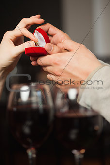 Close up on a woman taking the ring during marriage proposal