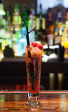 Close up on colourful cocktail with strawberries on the edge