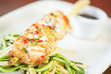 Asian fish dish with noodles and julienne vegetables