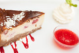 Cheesecake with chantilly cream and coulis close up