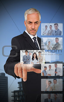 Experienced classy businessman using digital interface