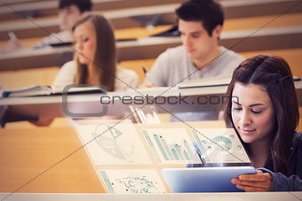 Pretty student in university working on her futuristic tablet