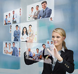 Blonde businesswoman selecting image from digital interface