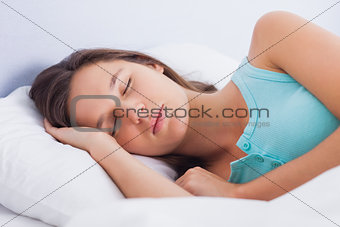 Brunette asleep in bed