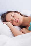 Brunette woman asleep in bed