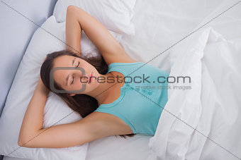 Brunette sleeping peacefully in bed