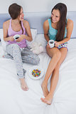 Friends sitting with coffee in bed