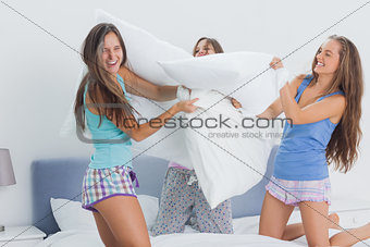 Friends having pillow fight