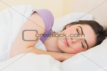 Smiling girl sleeping in her bed